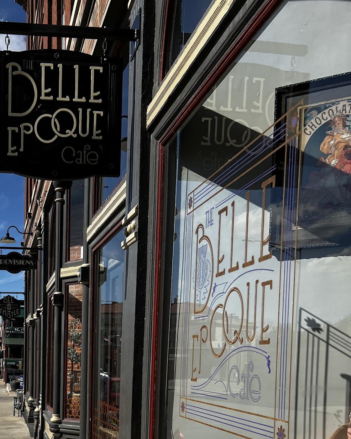 The storefront on Frederick Avenue: a hanging blade sign reading The Belle Epoque Cafe, and the same wordmark in gold leaf on the window.